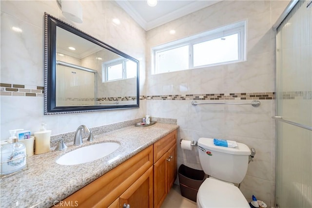 bathroom with tile walls, ornamental molding, vanity, walk in shower, and toilet