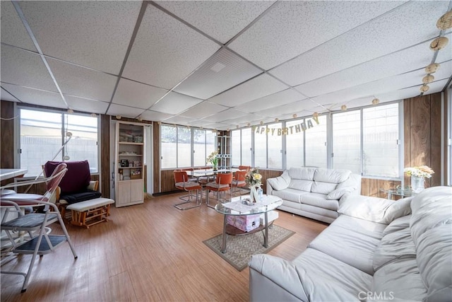 living room featuring hardwood / wood-style flooring and a paneled ceiling