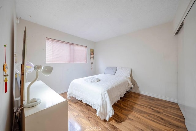 bedroom with hardwood / wood-style flooring