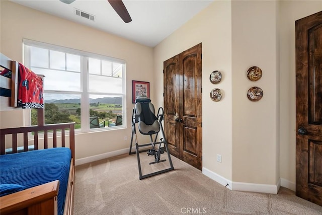 bedroom featuring ceiling fan and light carpet