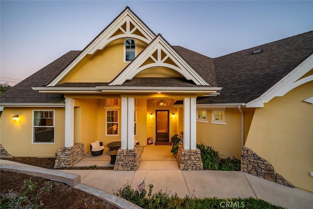 exterior entry at dusk with a porch