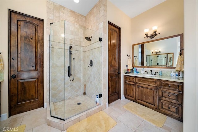 bathroom featuring vanity, a shower with shower door, and tile patterned flooring