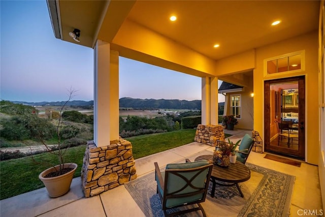 patio terrace at dusk with a mountain view