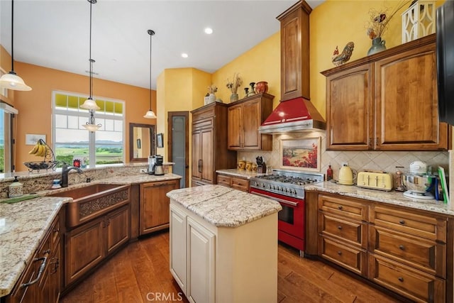 kitchen featuring range, a center island, hanging light fixtures, and light stone countertops