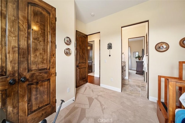 hallway with light colored carpet