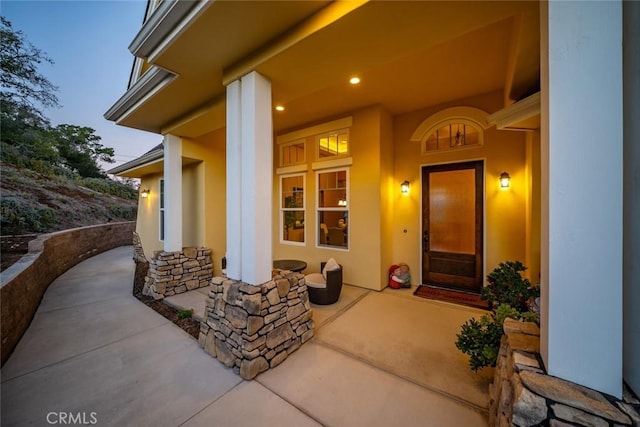 exterior entry at dusk with covered porch