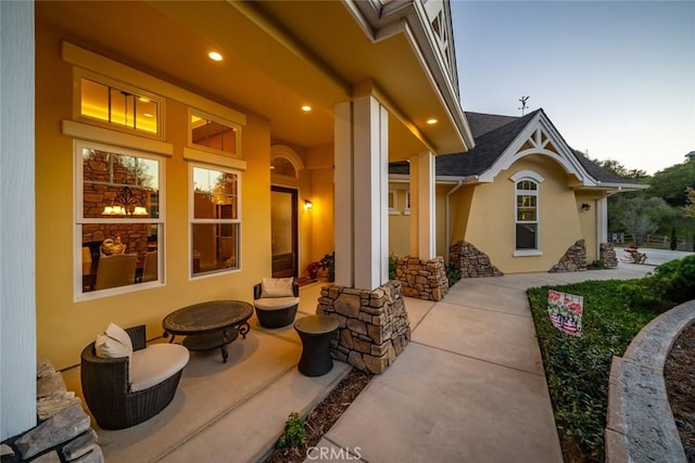 patio terrace at dusk featuring an outdoor fire pit