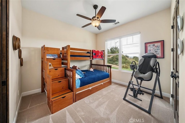 bedroom featuring ceiling fan and light carpet