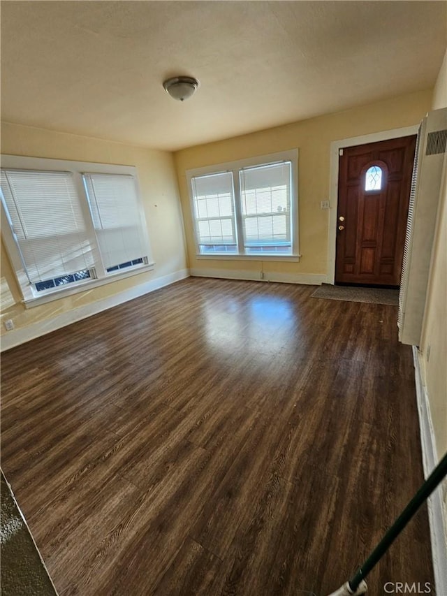 foyer featuring baseboards, dark wood-style flooring, and a healthy amount of sunlight