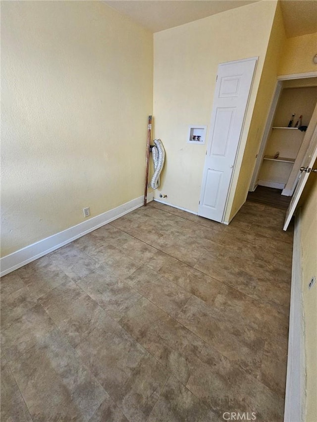 clothes washing area featuring baseboards and hookup for a washing machine