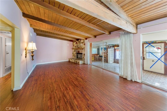 unfurnished living room with beamed ceiling, wood-type flooring, a fireplace, and wooden ceiling