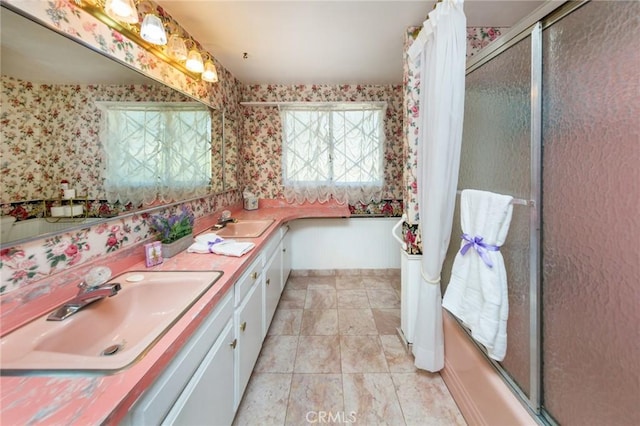 bathroom with vanity and bath / shower combo with glass door