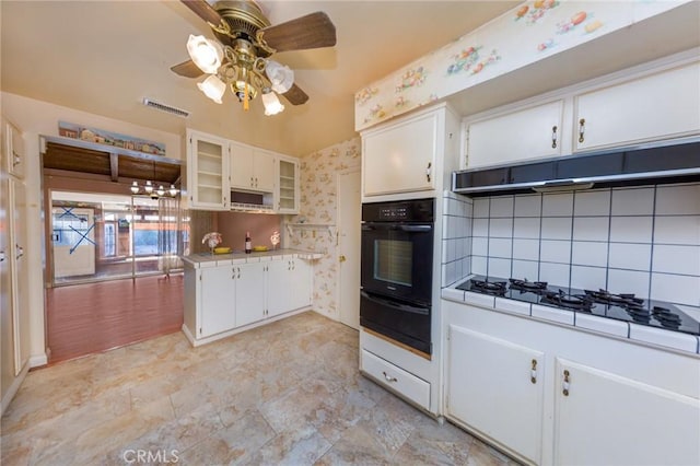 kitchen with black oven, white cabinets, decorative backsplash, ceiling fan, and white gas cooktop