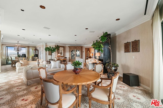 dining area with crown molding and a notable chandelier