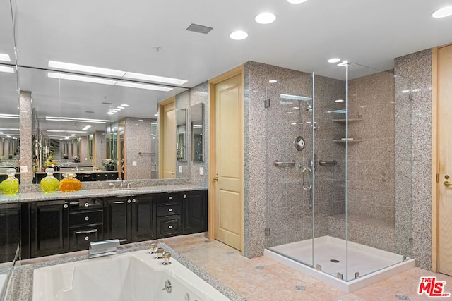 bathroom with vanity and independent shower and bath