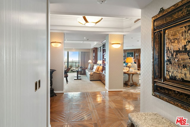 corridor with light parquet flooring and crown molding