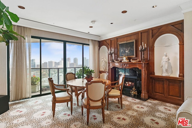 dining space with crown molding and a fireplace