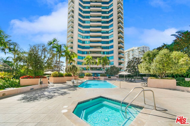 view of pool featuring a patio area and a hot tub