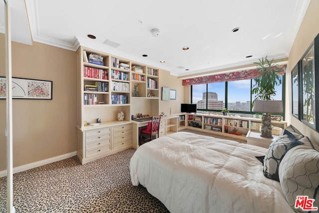 bedroom featuring ornamental molding, built in desk, and carpet floors