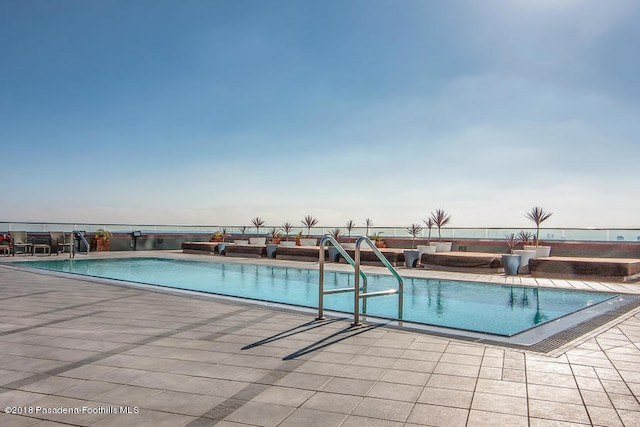 view of swimming pool with a patio