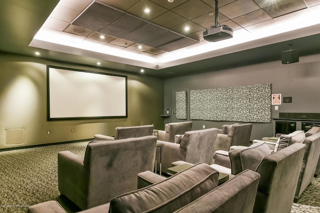 carpeted home theater with a raised ceiling