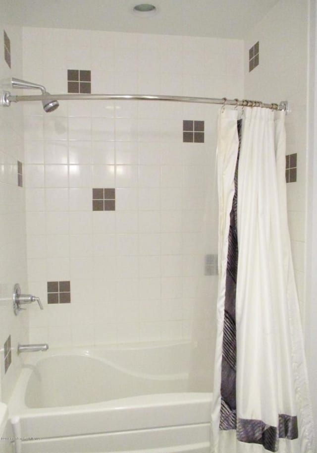 bathroom with shower / bathtub combination with curtain