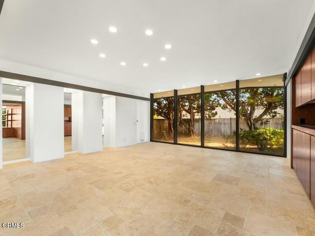 unfurnished room featuring floor to ceiling windows