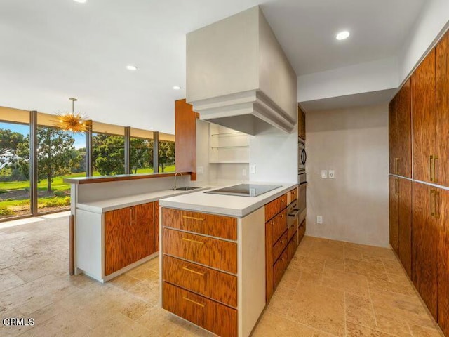 kitchen with black electric cooktop, sink, built in microwave, and kitchen peninsula