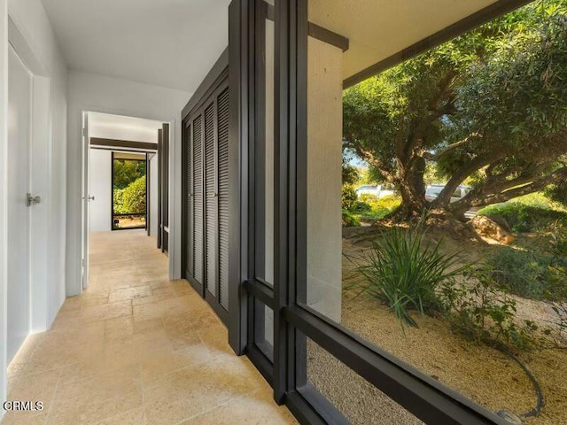 hall featuring stone tile flooring