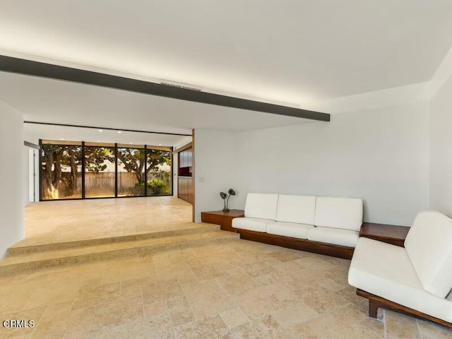 living area with beamed ceiling