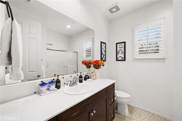 bathroom featuring walk in shower, vanity, toilet, and a wealth of natural light