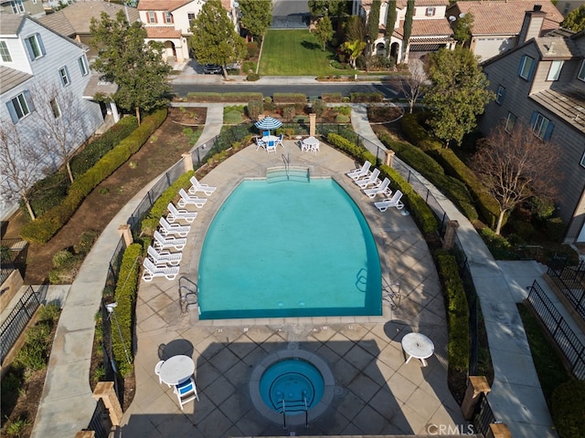 view of pool featuring a community hot tub and a patio area