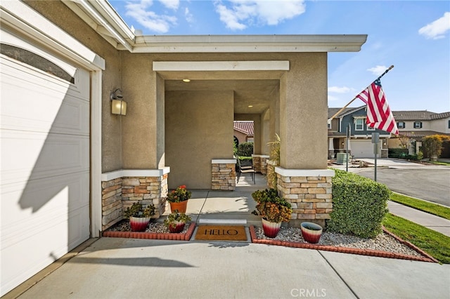 property entrance featuring a garage and covered porch