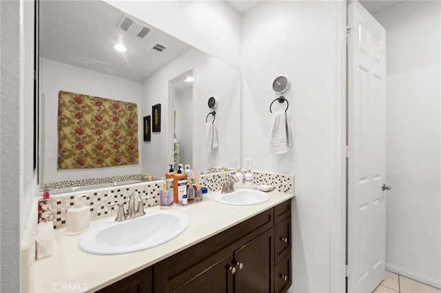 bathroom featuring vanity and backsplash