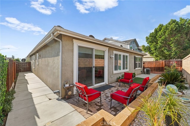 rear view of house with a patio and central AC unit