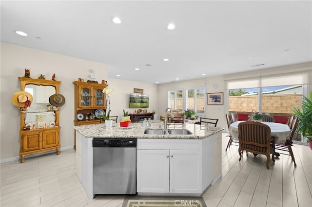 kitchen with white cabinetry, light stone countertops, sink, and stainless steel dishwasher