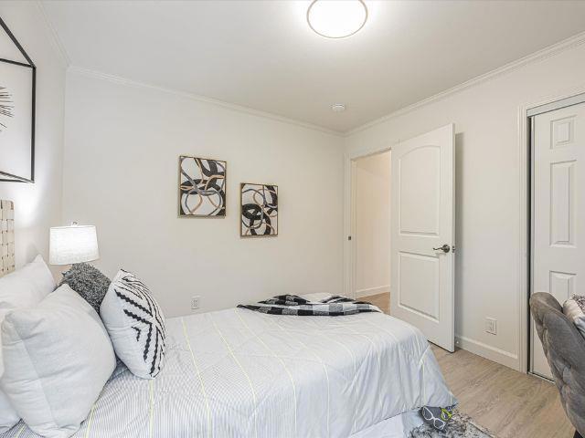 bedroom featuring ornamental molding, a closet, and light wood-type flooring