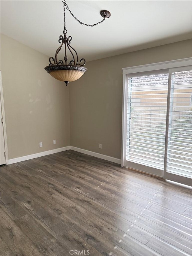 spare room with dark hardwood / wood-style floors