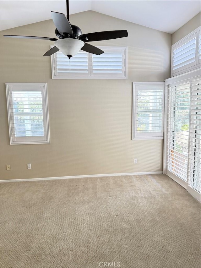 unfurnished room with ceiling fan, light colored carpet, a healthy amount of sunlight, and lofted ceiling