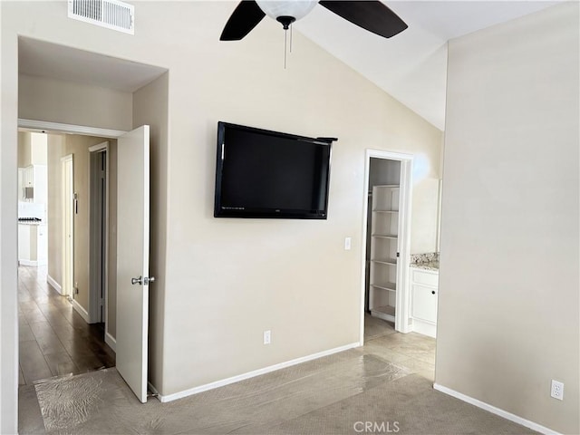 spare room featuring ceiling fan and lofted ceiling