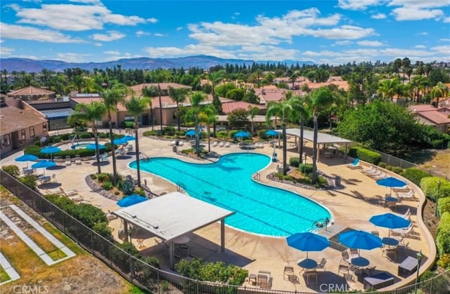 view of pool with a mountain view and a patio area