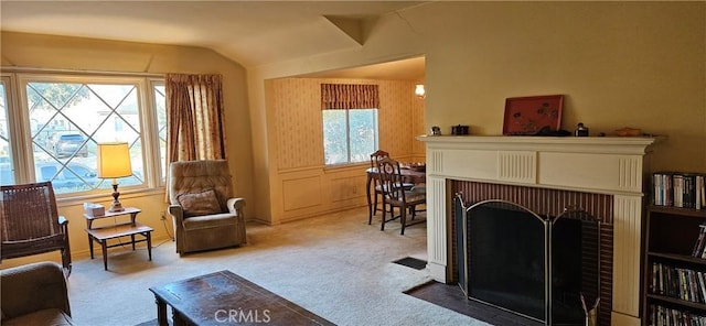 living area featuring light colored carpet and vaulted ceiling