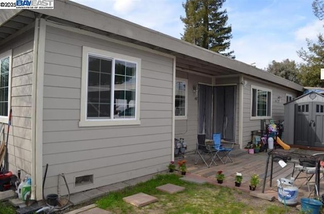 rear view of house featuring a shed