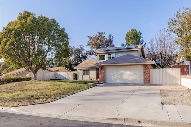 view of front of property with a garage, a front yard, and solar panels