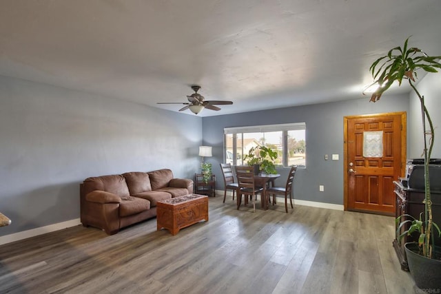 living room featuring hardwood / wood-style flooring and ceiling fan