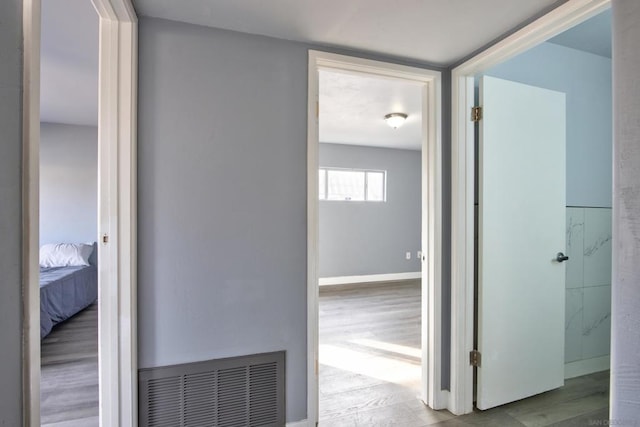 corridor with light hardwood / wood-style floors