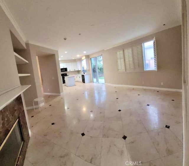 unfurnished living room featuring a wealth of natural light