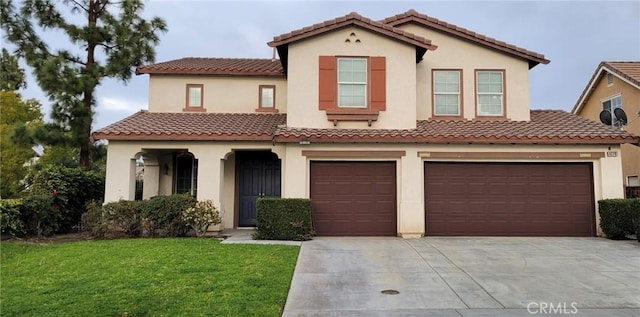 mediterranean / spanish house with a garage and a front yard