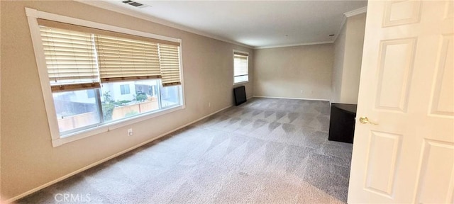 carpeted empty room featuring crown molding