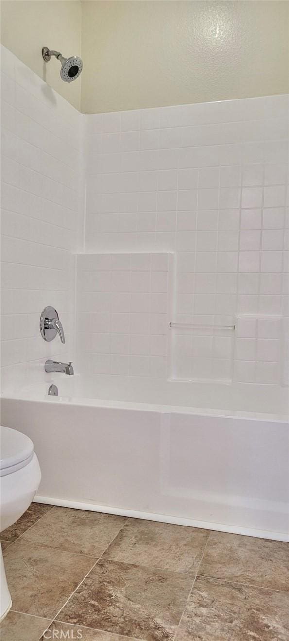 bathroom with shower / washtub combination and toilet